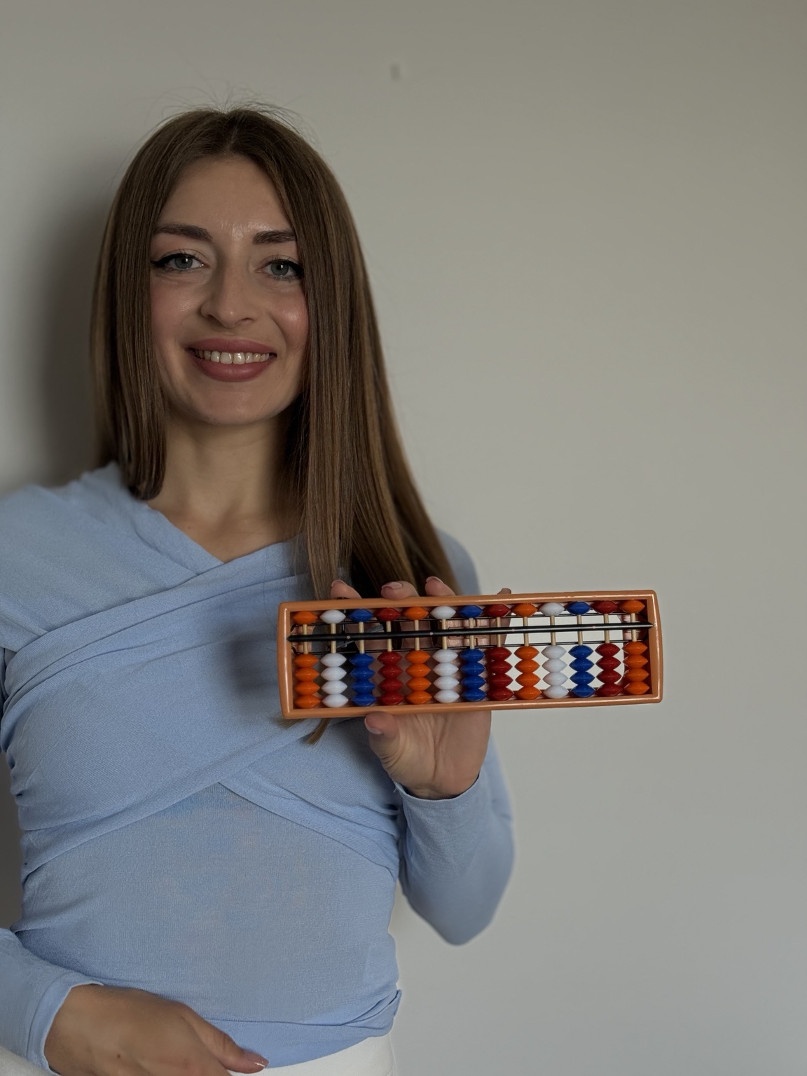 Math Abacus for Kids teacher holding a teaching abacus