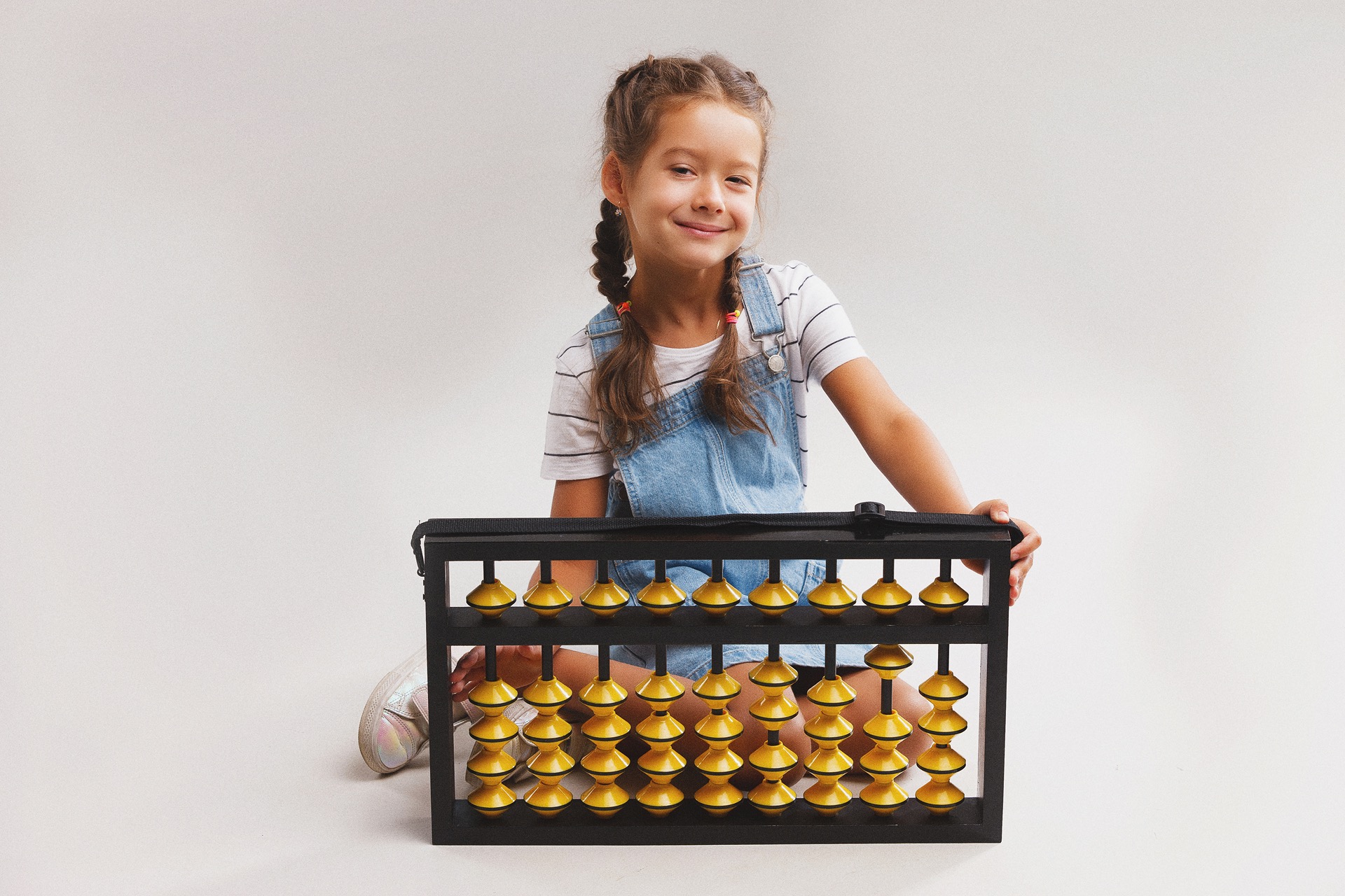 Pupil using a large teaching abacus
